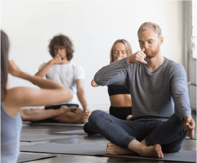 Yoga training - people meditating with flinger on one nostril