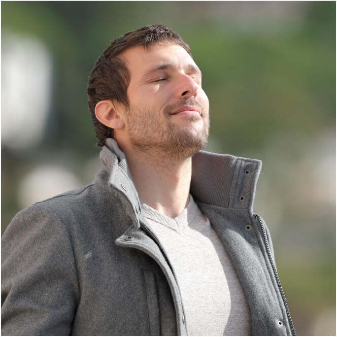 Young man breathing through the nose with eyes closed